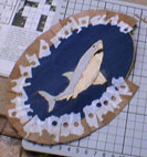 The crossbanding being taped onto the shark motif