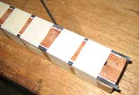 The ebony stringing on the legs being glued into place